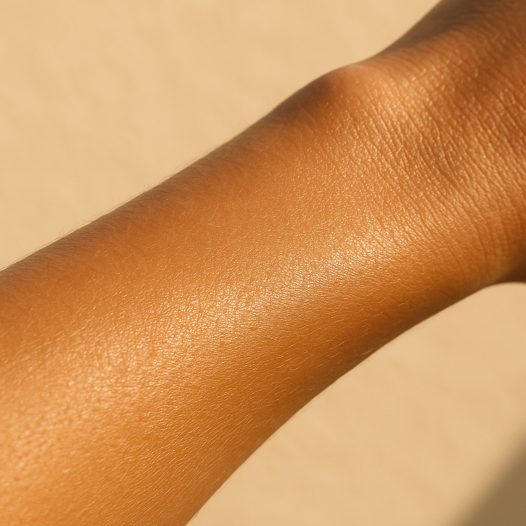 A bottle of moisturizing skincare product in the foreground on a sandy beach, with gentle waves and sunlit sand in the background, capturing Mullaloo's coastal climate and emphasizing skin protection.