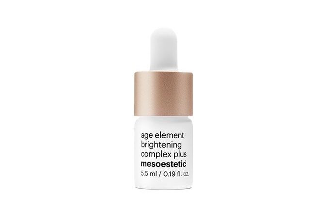 Brightening serum bottle with dropper, gold and white design.