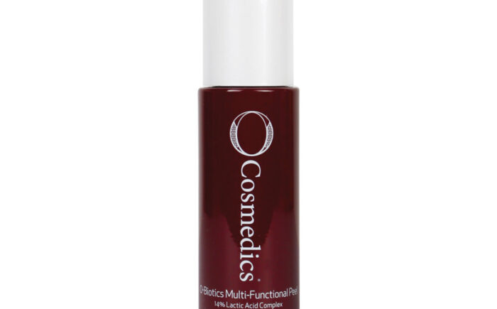 Dark red bottle labeled O Cosmedics skincare product.