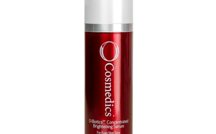 O Cosmedics brightening serum bottle with red packaging.