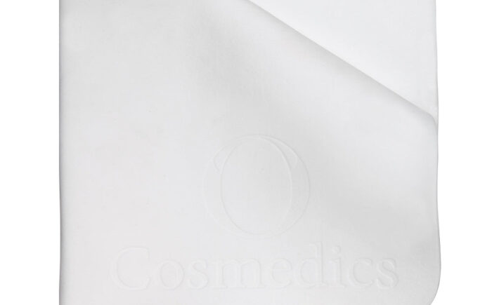 White O Cosmedics-branded towel neatly folded, minimalist design.