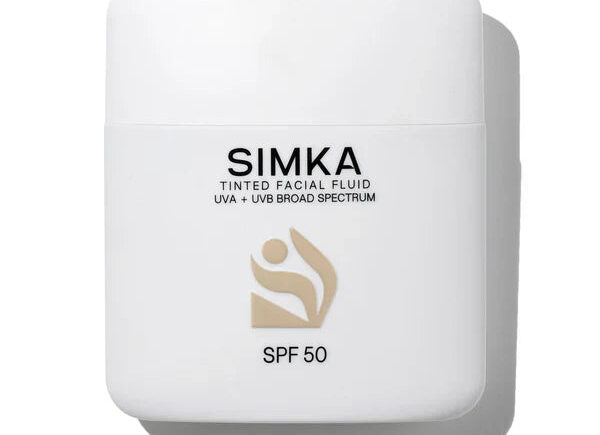 Minimalist white SPF 50 tinted facial fluid packaging.