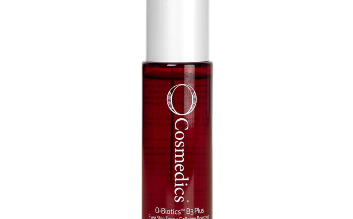 Red bottle of O Cosmedics skincare product with white cap.